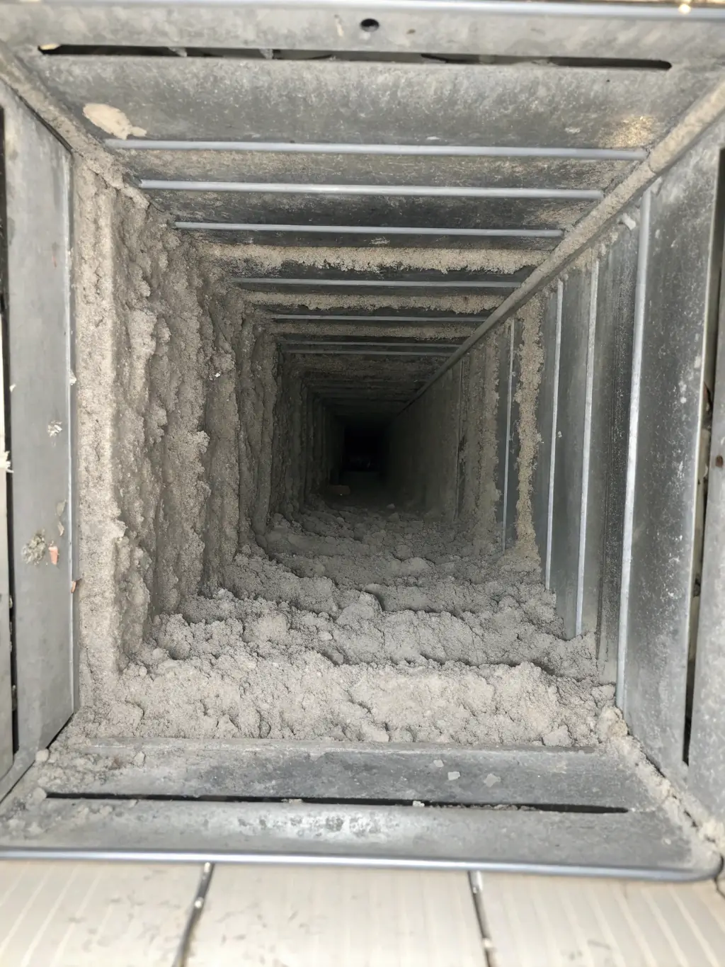A close-up shot of a clean, shiny duct interior, free of dust and debris, symbolizing improved air quality.